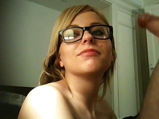 Fair haired teen girlfriend gets fucked hard in her tight wet pussy before her BF shoots his load on her face and she keeps her glasses on. She eagerly poses on camera with cum on the glasses.